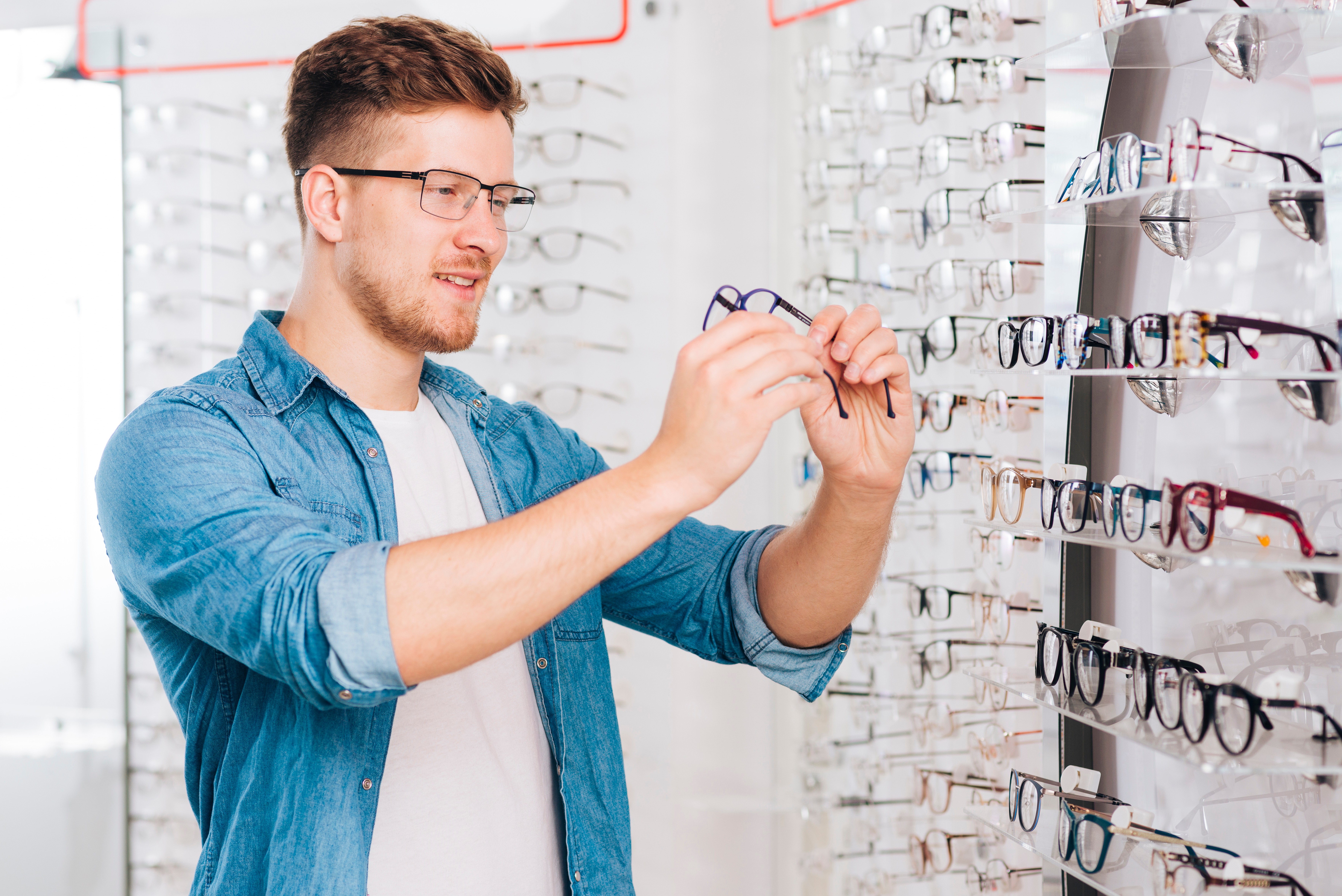 Professional optician helping customer choose frames